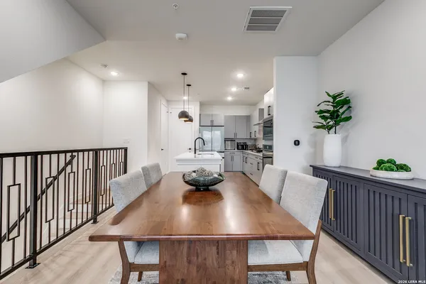 a view of a dining room with furniture and a potted plant