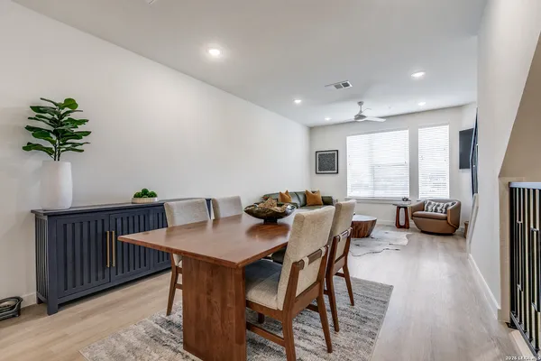 a view of a dining room with furniture and a potted plant