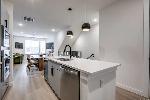 a large kitchen with a table and chairs