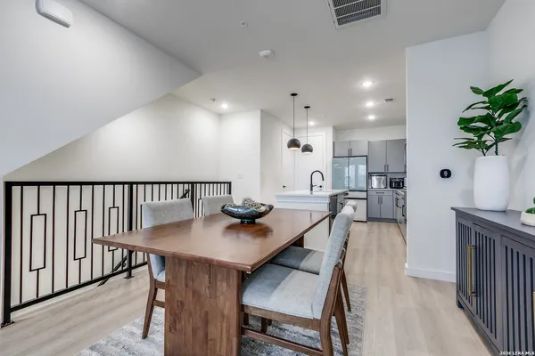 a view of a dining room with furniture and a potted plant