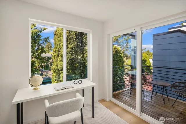 a dining room with a wooden table and chairs