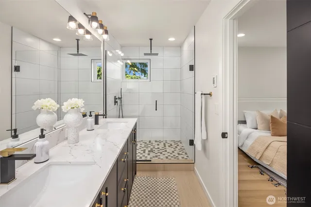 a bathroom with a sink mirror and shower
