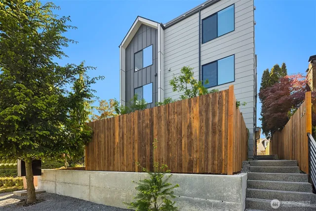 a view of a house with a potted plant and floor to ceiling window