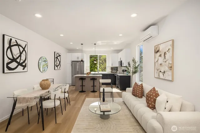 a living room with furniture and kitchen view
