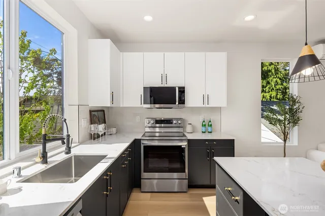 a kitchen with a sink stove and microwave