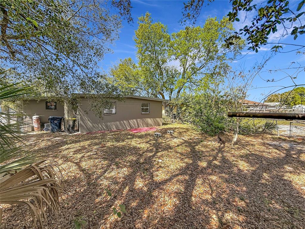 319 Leta Street Auburndale, FL 33823 - Photo 12 of 45 a backyard of a house with lots of green space