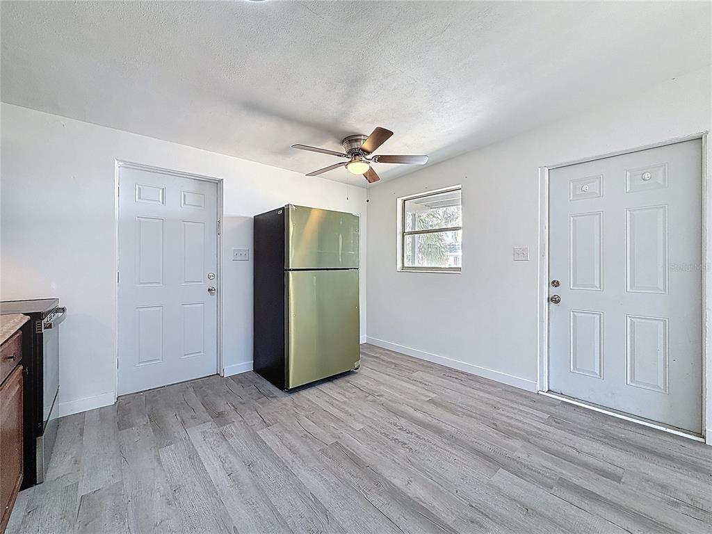 319 Leta Street Auburndale, FL 33823 - Photo 15 of 45 an empty room with wooden floor and a ceiling fan