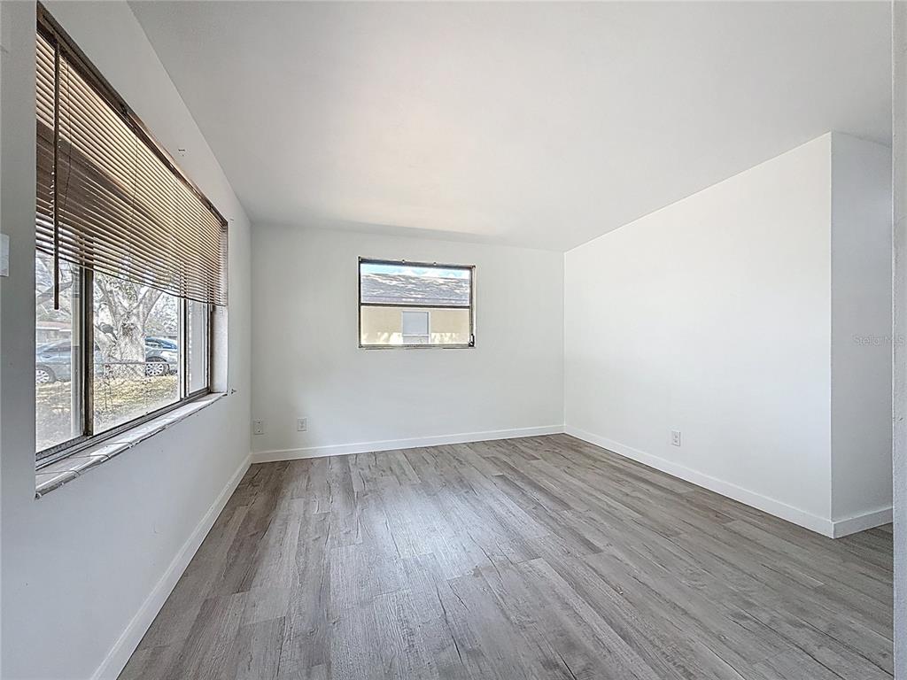 319 Leta Street Auburndale, FL 33823 - Photo 18 of 45 an empty room with wooden floor and windows
