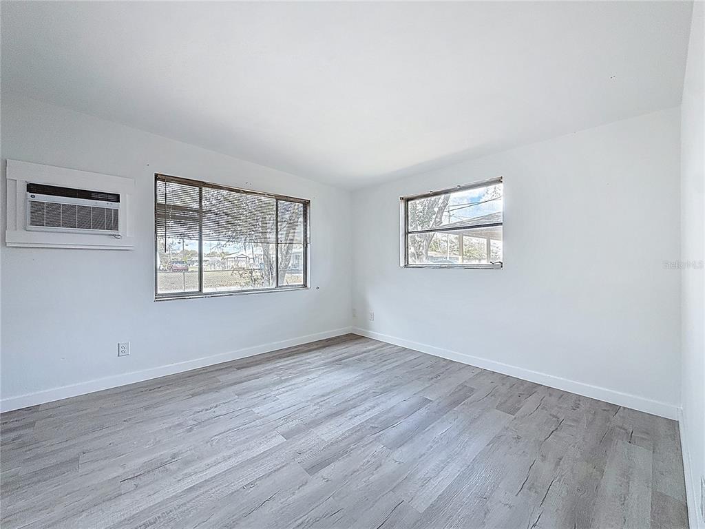 319 Leta Street Auburndale, FL 33823 - Photo 19 of 45 an empty room with wooden floor and windows