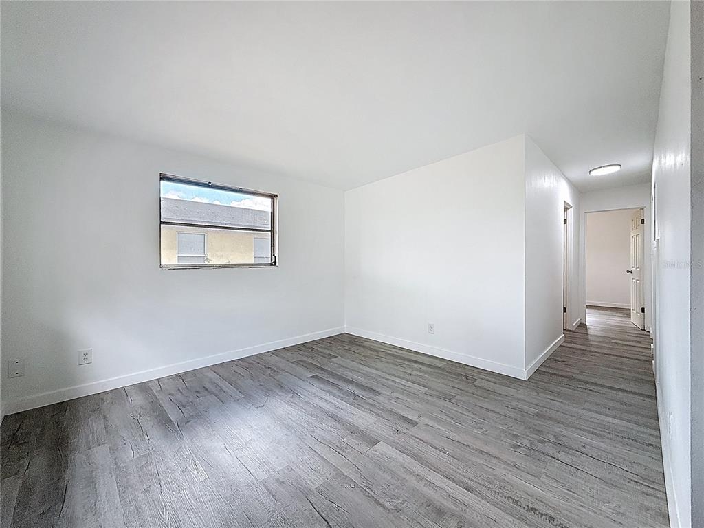 319 Leta Street Auburndale, FL 33823 - Photo 20 of 45 an empty room with wooden floor and windows