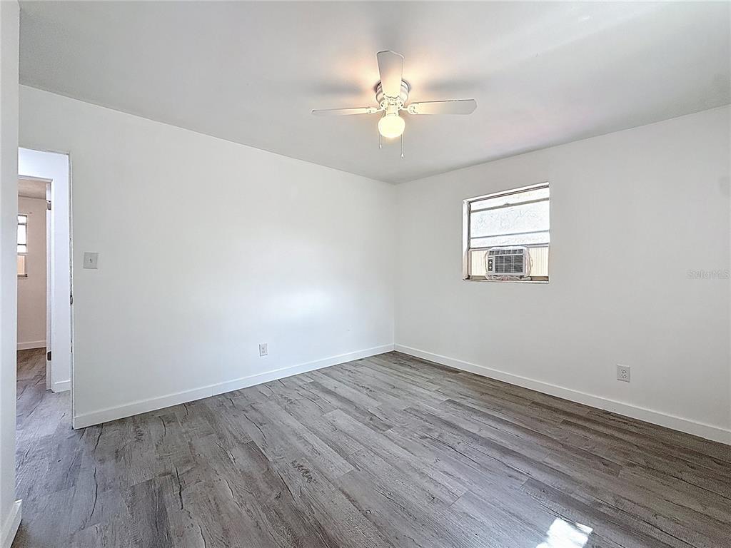319 Leta Street Auburndale, FL 33823 - Photo 21 of 45 wooden floor in an empty room with a window