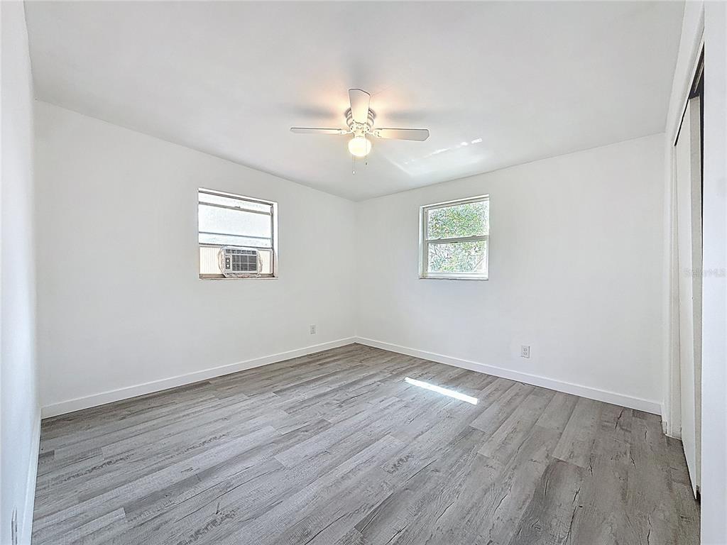 319 Leta Street Auburndale, FL 33823 - Photo 24 of 45 a view of an empty room with wooden floor and a window