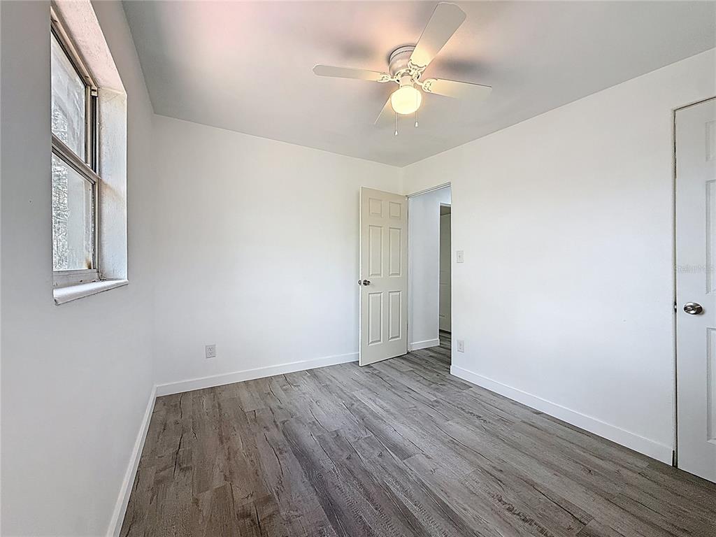 319 Leta Street Auburndale, FL 33823 - Photo 26 of 45 an empty room with wooden floor and windows