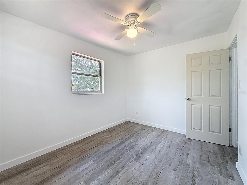 319 Leta Street Auburndale, FL 33823 - Photo 27 of 45 wooden floor in an empty room with a window