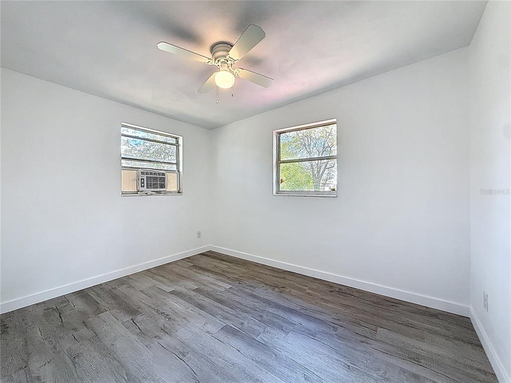 319 Leta Street Auburndale, FL 33823 - Photo 28 of 45 a view of an empty room with wooden floor and a window