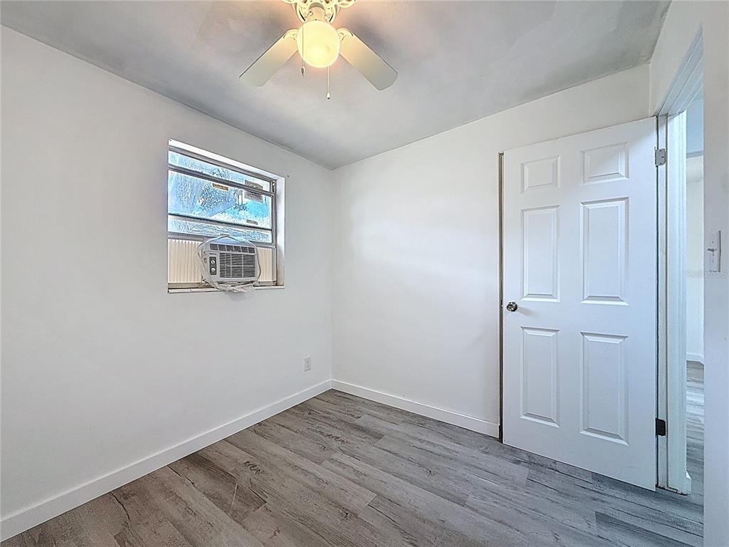 319 Leta Street Auburndale, FL 33823 - Photo 29 of 45 an empty room with wooden floor and windows