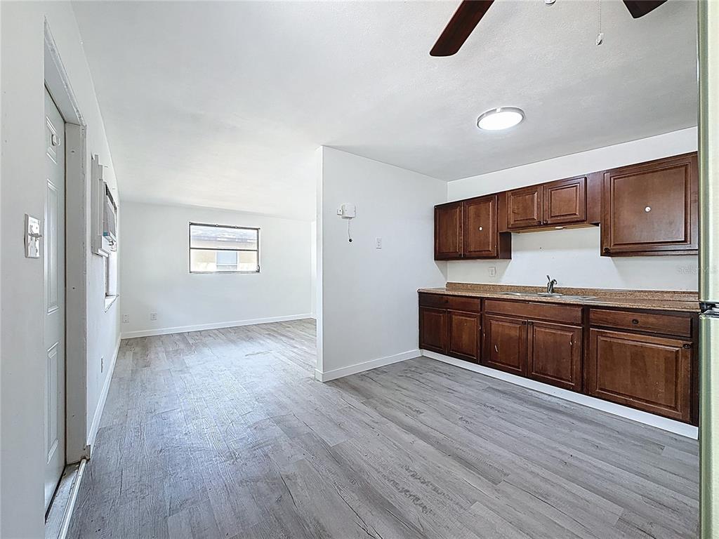 319 Leta Street Auburndale, FL 33823 - Photo 3 of 45 a kitchen with stainless steel appliances granite countertop a sink a stove a microwave a counter space and cabinets