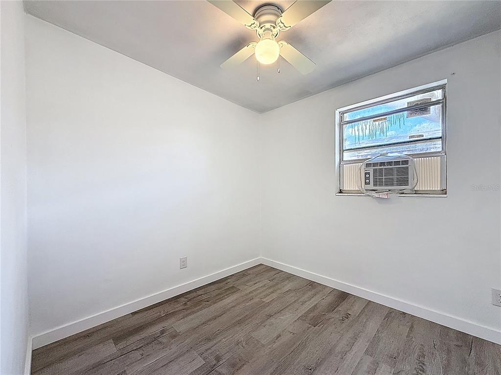319 Leta Street Auburndale, FL 33823 - Photo 32 of 45 wooden floor in an empty room with a window