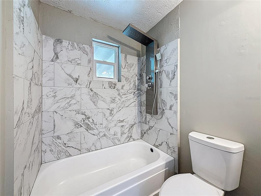 319 Leta Street Auburndale, FL 33823 - Photo 5 of 45 a bathroom with a toilet and a bathtub