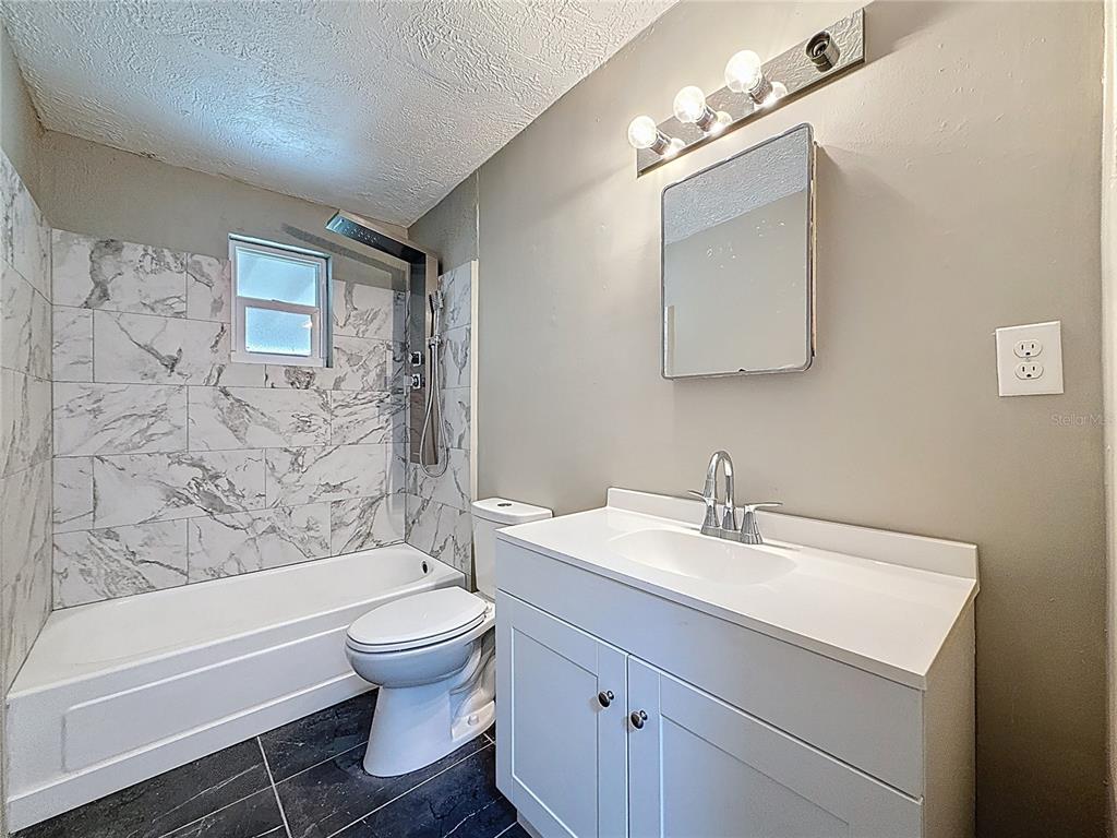 319 Leta Street Auburndale, FL 33823 - Photo 6 of 45 a bathroom with a sink a toilet and a bathtub