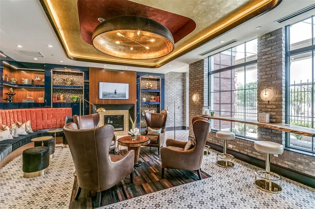 a dining room with furniture and a floor to ceiling window