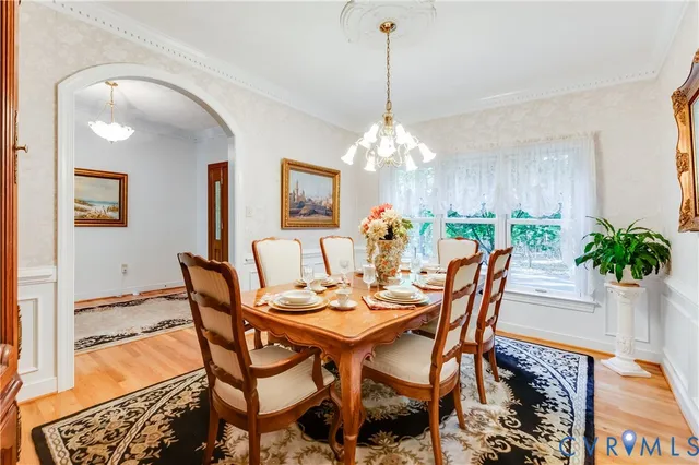 a view of a dining room with furniture and chandelier
