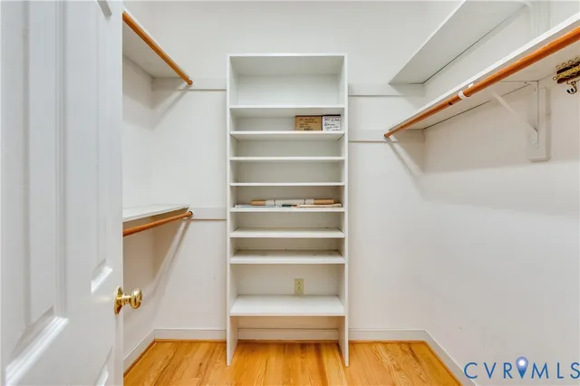 a view of walk in closet with empty racks