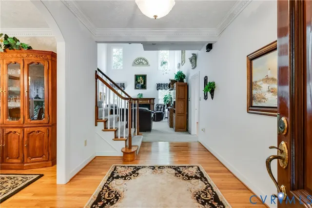a view of entryway and hall with wooden floor
