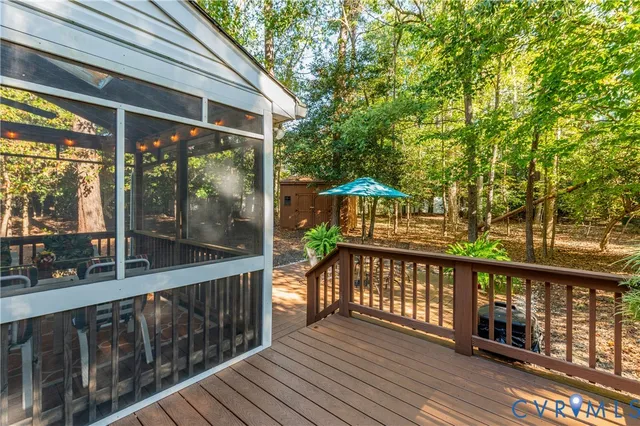 a view of a wooden deck with a yard
