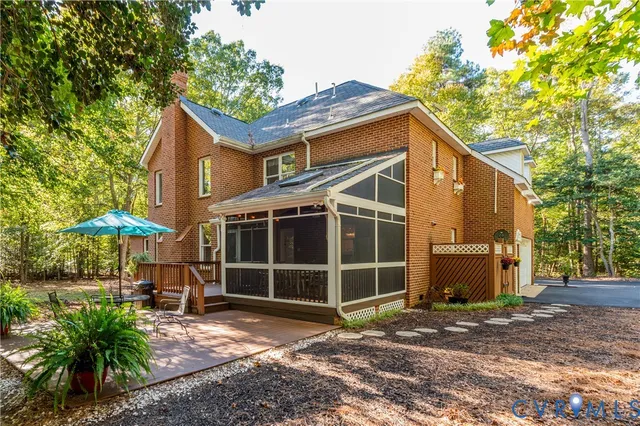 a view of a house with a yard and a large tree