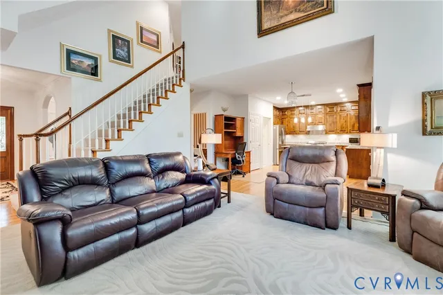 a living room with furniture and a dining table