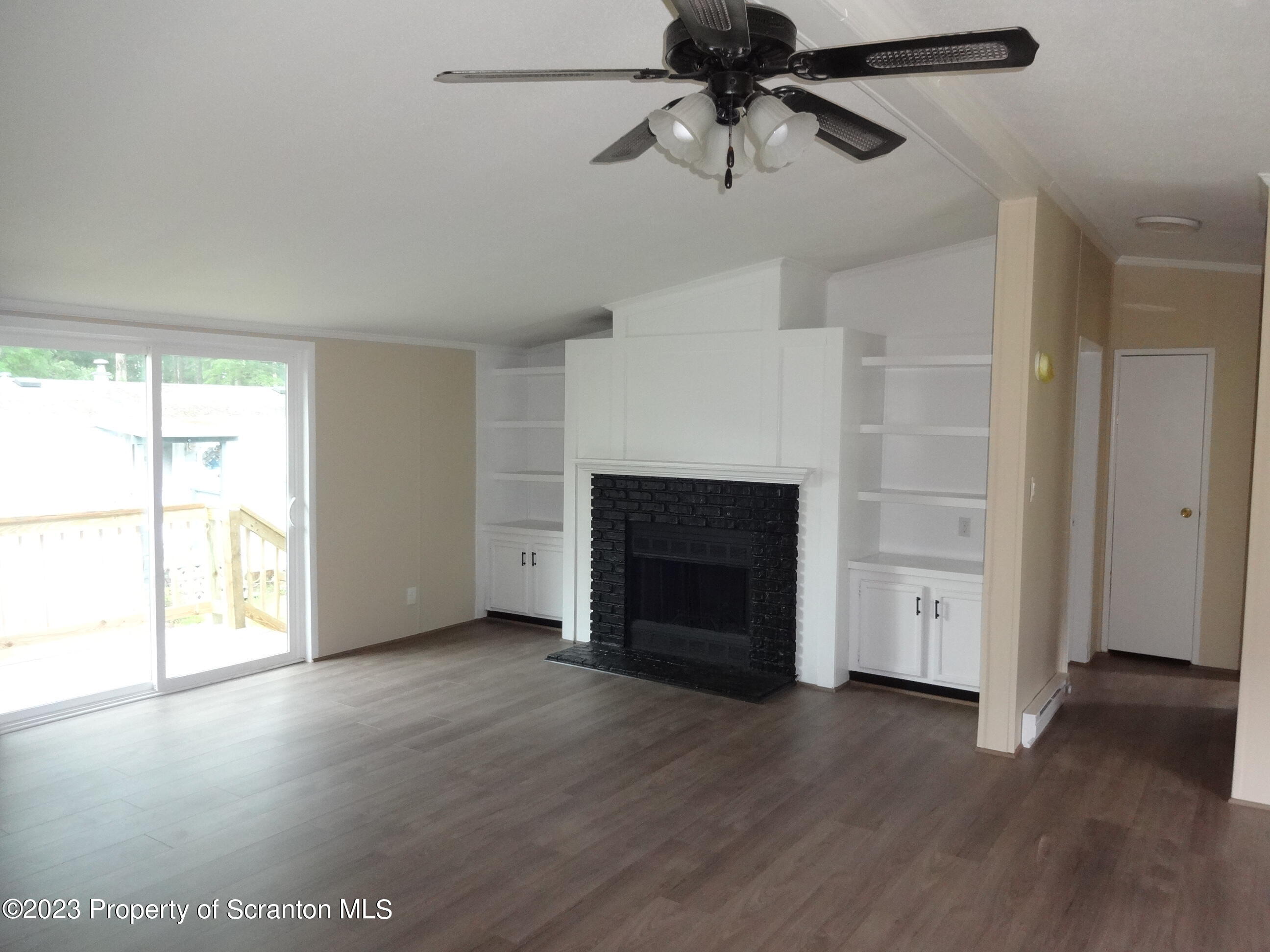 16 Hi View Terrace Lake Ariel, PA 18436 - Photo 2 of 23 an empty room with windows and fireplace