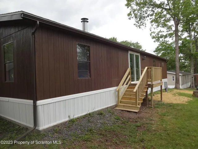 a wooden bench sitting in front of a house