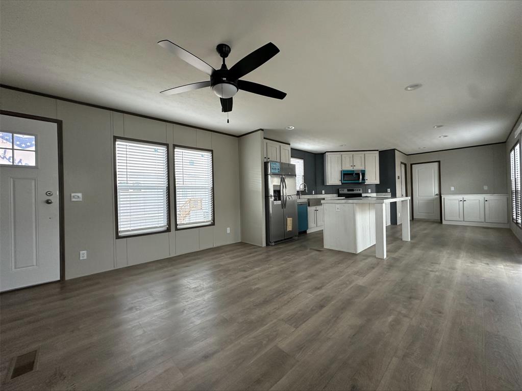 14 Liberty Road Crowley, TX 76036 - Photo 5 of 10 Kitchen featuring hardwood / wood-style floors, appliances with stainless steel finishes, a center island, white cabinetry, and ceiling fan