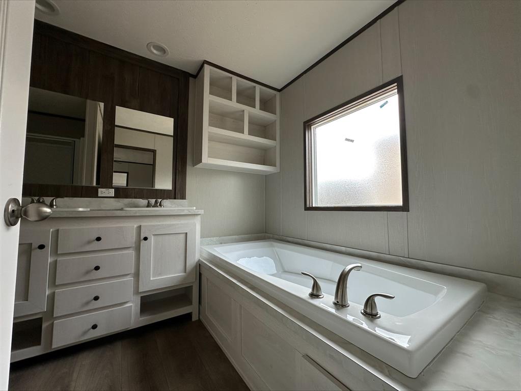 14 Liberty Road Crowley, TX 76036 - Photo 7 of 10 Bathroom featuring vanity, wood-type flooring, and a washtub