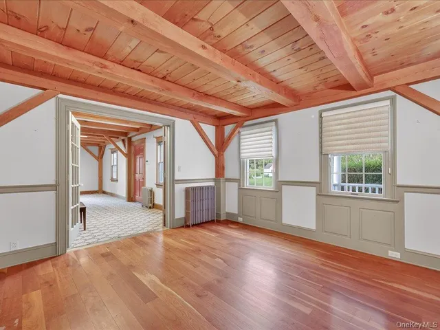 a view of a hallway with wooden floor and a fireplace
