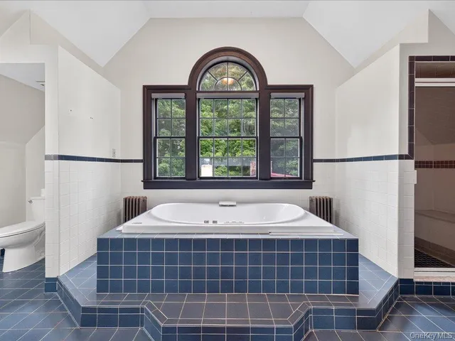 a bathroom with a tub and a window