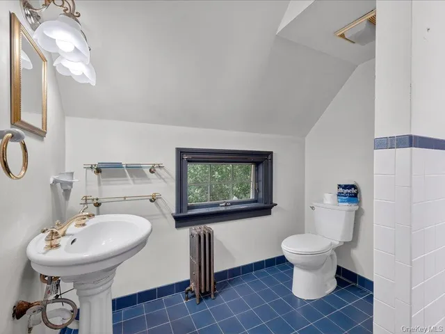 a backyard of a house with a table and chairs potted plants