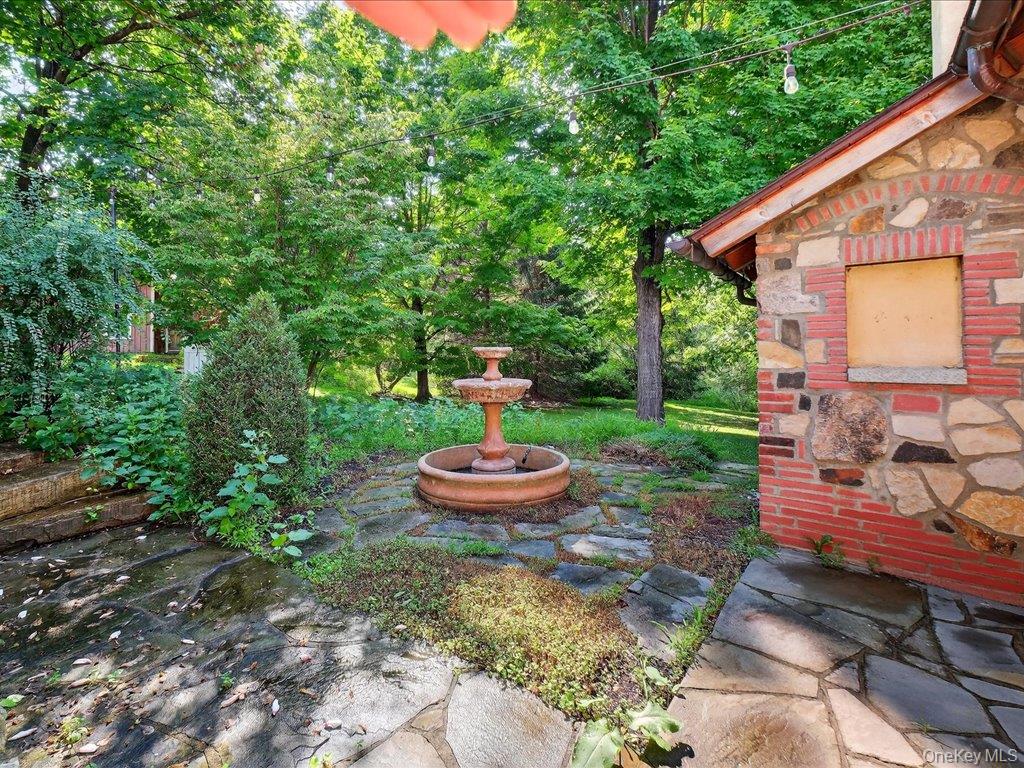 121 Valley Farm Road Millbrook, NY 12545 - Photo 22 of 34 a backyard of a house with a table and chairs potted plants