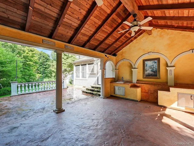 a view of a house with a yard and potted plants