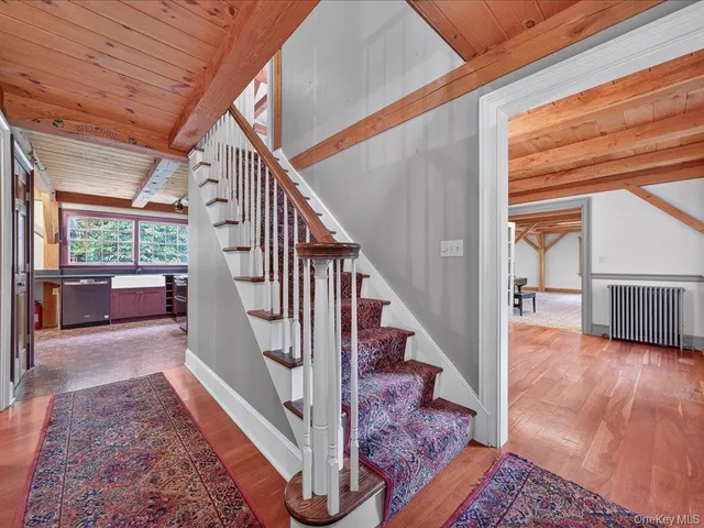 a view of entryway and hall with wooden floor