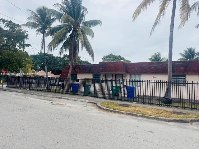 a view of a house with swimming pool and sitting area