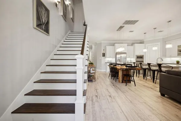 a view of entryway and hall with wooden floor