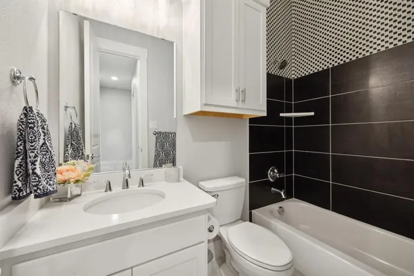 a bathroom with a sink toilet vanity and shower
