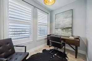 a view of a workspace with furniture and a window