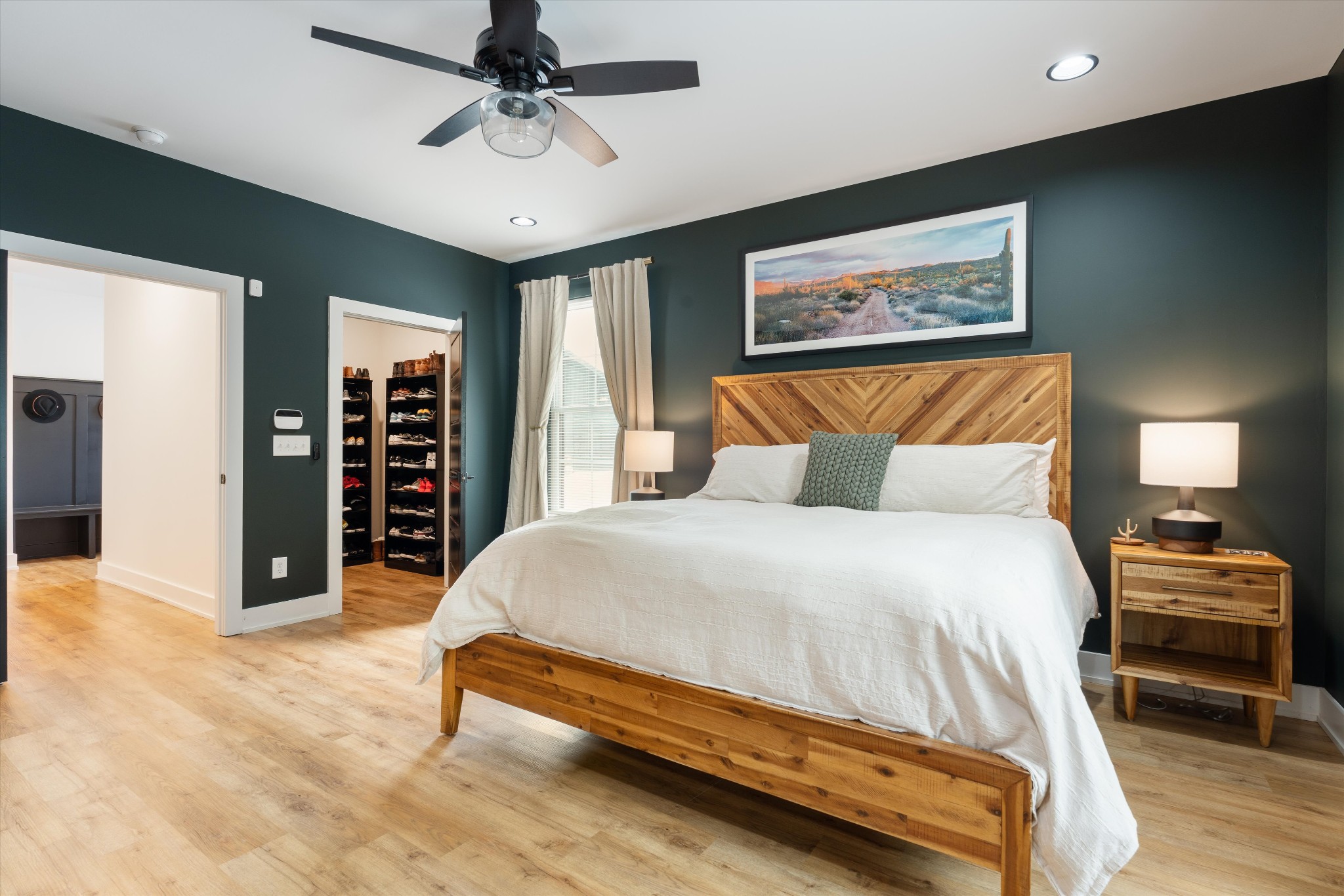 290 Dink Rut Road Portland, TN 37148 - Photo 27 of 66 a bedroom with a large bed and a chandelier