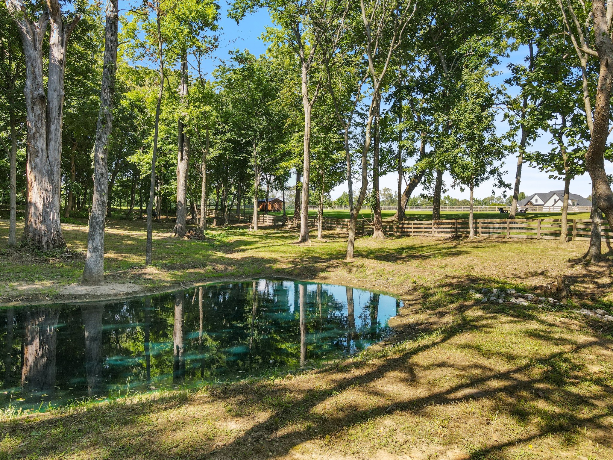 290 Dink Rut Road Portland, TN 37148 - Photo 64 of 66 a view of a lake with a house in the background
