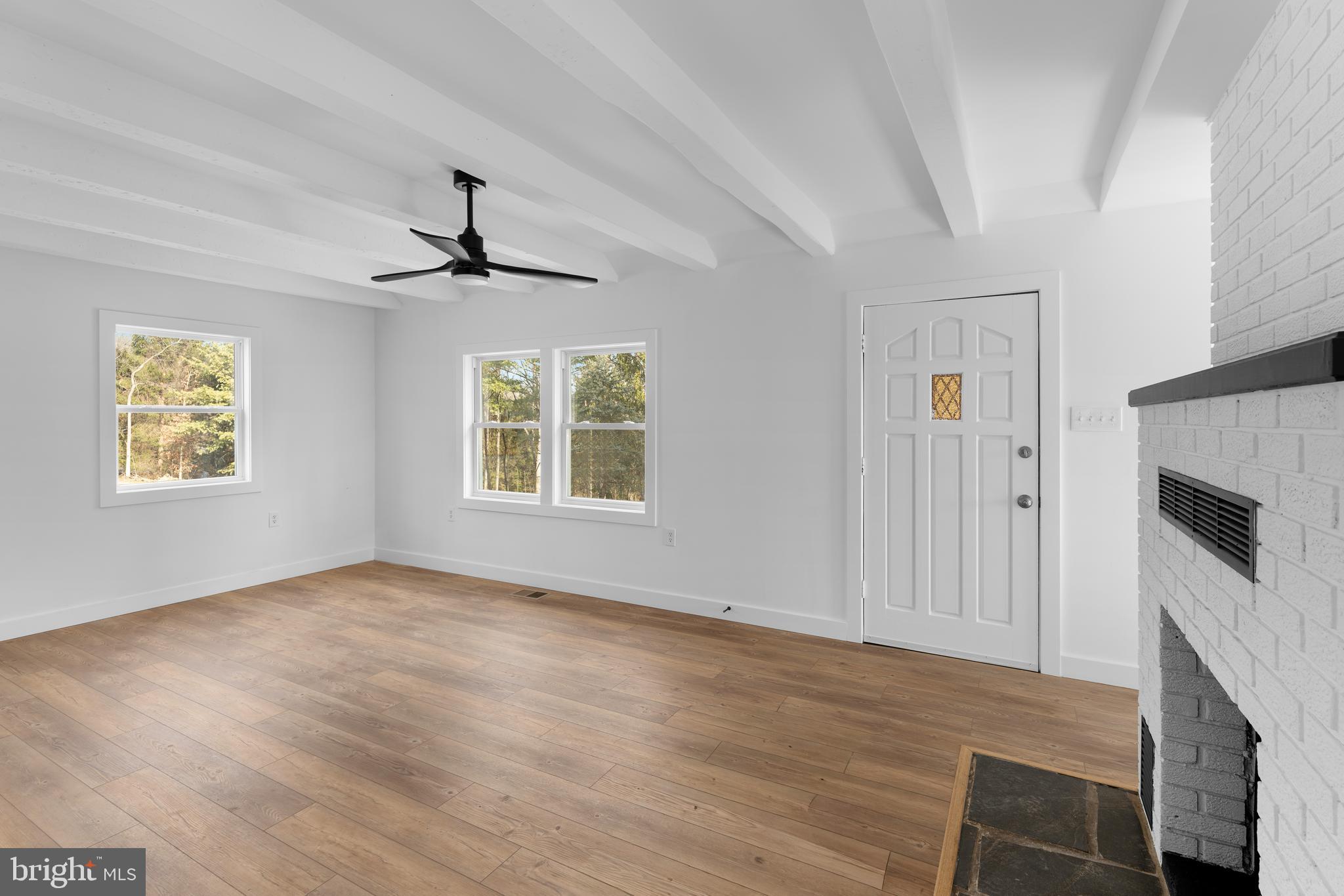 351 Ridgeview Road Gore, VA 22637 - Photo 18 of 31 an empty room with windows and chandelier fan