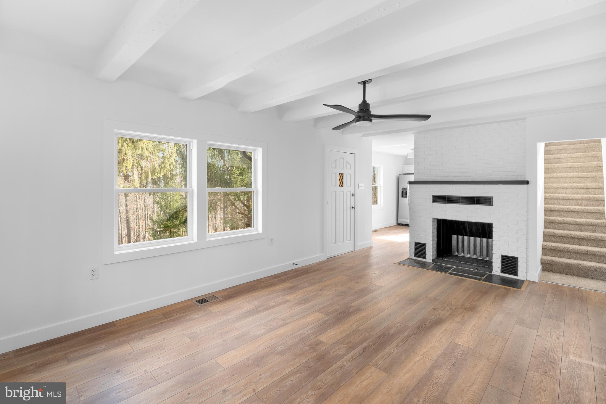 351 Ridgeview Road Gore, VA 22637 - Photo 19 of 31 wooden floor fireplace and windows in an empty room