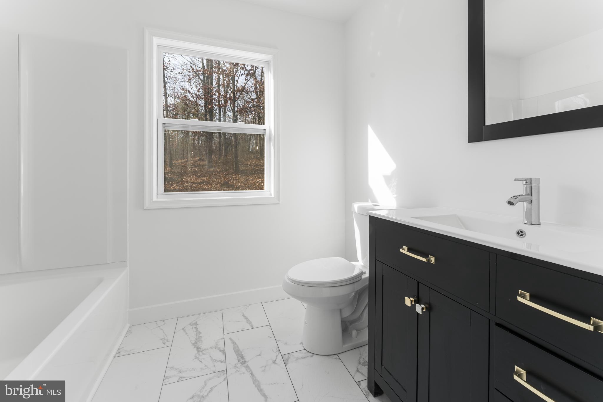 351 Ridgeview Road Gore, VA 22637 - Photo 21 of 31 a bathroom with a sink toilet and vanity